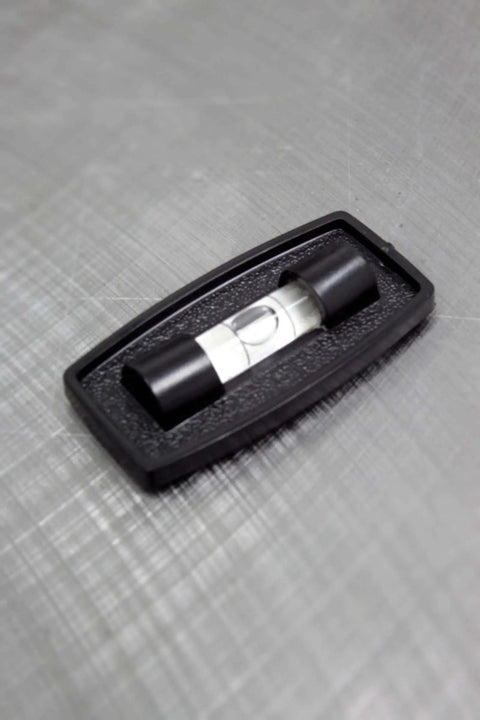 Never Fade Two Way Stick On Level Black With Self Adhesive Back For Quick Plumb And Level Checks, shown on textured surface