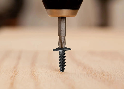 Drilling 250 Count Black Truss Head Wood Screws 1 Inch Self Tapping Carbon Steel With Black Phosphate Coating into wood surface
