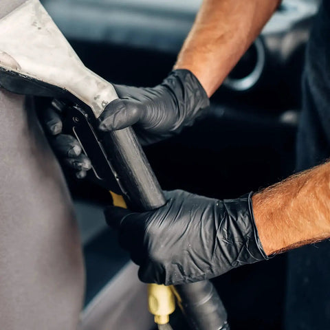 Person wearing Black Vinyl Disposable Exam Gloves 4 Mil Latex Free Powder Free Medical 1000 while cleaning with a tool