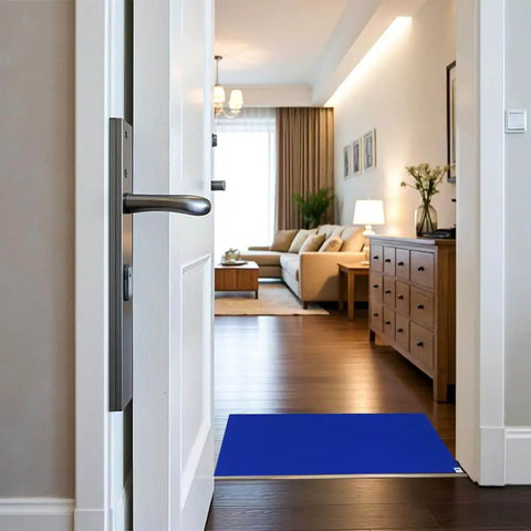 Blue adhesive sticky floor mat 24x36 inches at entryway, peel and stick tacky pad for construction sites, labs, cleanrooms, hospitals, and sports shoes.