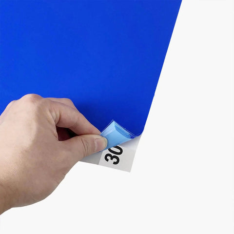 Person peeling Adhesive Sticky Floor Mats 24 By 36 Inches For Construction Sites Labs Cleanrooms Hospitals And Sports Shoes Blue 12 Pack