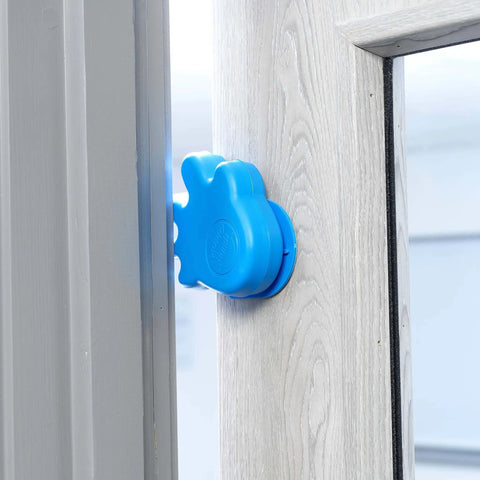 Anti Slam Door Safety For Kids Two Pack Finger Trap Stoppers With Adhesive Pad, blue plastic guard installed on door handle.