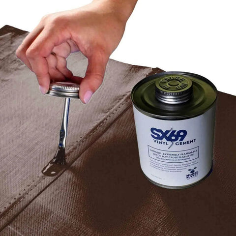 Hand applying 4oz SX-69 adhesive from a can onto a surface, part of the Vinyl Repair Kit For Inflatables With 12x60 Inch Blue Marble Patch Roll