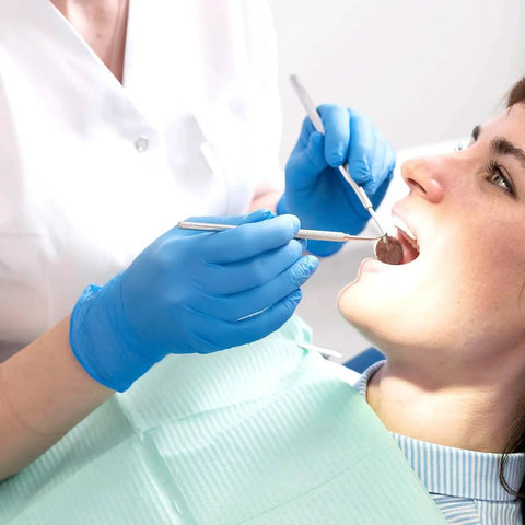 Dentist wearing Blue Nitrile Exam Gloves Medical Grade Size M 1000 Count Latex Free Disposable while examining a patient