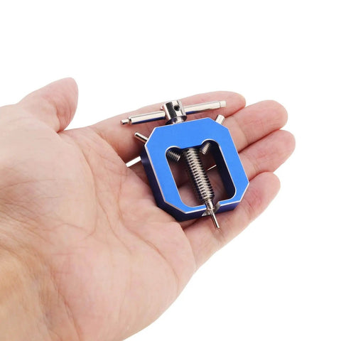 Hand holding blue RC Motor Pinion Gear Puller Set Universal Gear Puller Remover For Vehicle Models And Small Motors