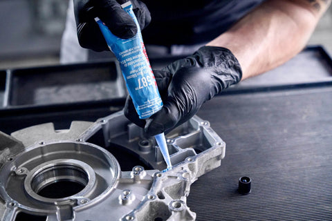 Applying Auto Grade RTV Silicone Gasket Maker Blue 587 Pro Grade High Temp Oil Resistant Sensor Safe Non Corrosive Sealant on engine
