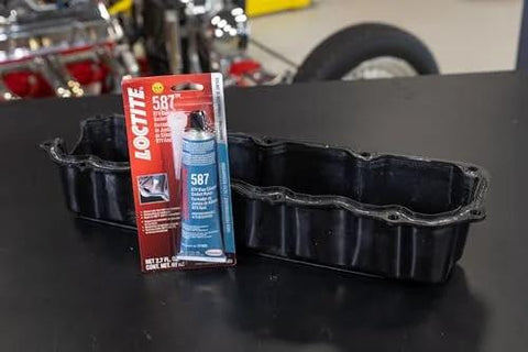 Auto Grade RTV Silicone Gasket Maker Blue 587 Pro Grade High Temp Oil Resistant Sensor Safe Non Corrosive Flexible Sealant For Engine Gaskets And Vehicle Repairs 80 Ml 1 Pack shown with engine part.