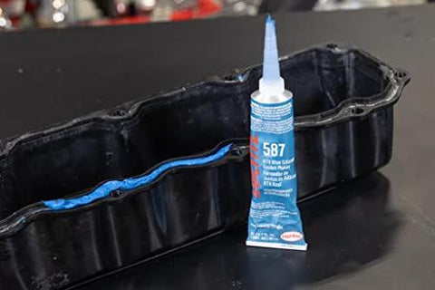 Auto Grade RTV Silicone Gasket Maker Blue 587 Pro Grade High Temp Oil Resistant Sensor Safe Non Corrosive Flexible Sealant For Engine Gaskets And Vehicle Repairs 80 Ml 1 Pack shown next to an engine gasket
