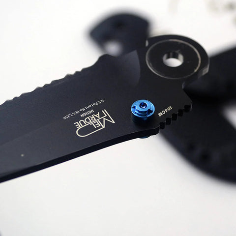 Close-up of a knife with blue thumb stud, featuring ZYAMY 3pcs Thumb Studs, Titanium Screws Replacement Thumb Studs Pocket Blade Screws for 535 Bugout
