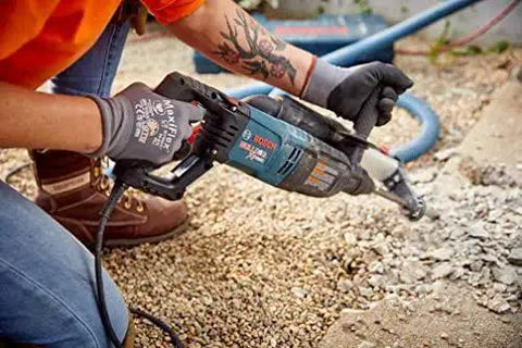 Bosch Bulldog Extreme 1 Inch SDS Plus Rotary Hammer in use on concrete, showing powerful corded performance with an 8 Amp motor.