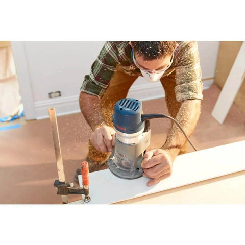Person using 1617EVSPK Combo Router With Plunge And Fixed Base, 2.25 HP Motor, 8,000 to 25,000 RPM on woodworking project