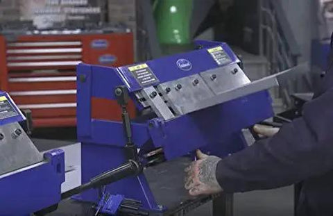 24 Inch Box And Pan Sheet Metal Brake With Five Adjustable Fingers for Small Shops shown in a workshop setting, bending metal.