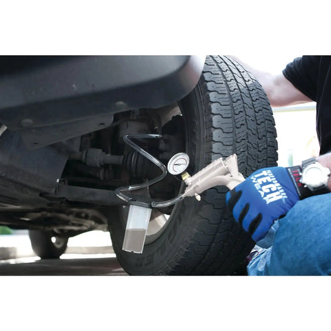 Mechanic using One Man Hand Vacuum Pump Kit For Brake Bleeding And Automotive Tests by Performance Tool on vehicle undercarriage