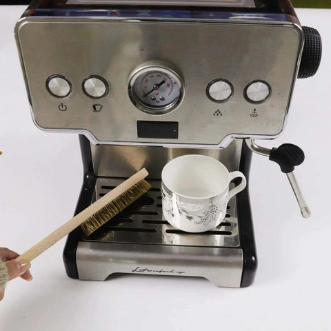 Soft Brass Bristle Wire Brush for Cleaning Metal Rust placed on a coffee machine tray next to a teacup, showing use for kitchen tasks