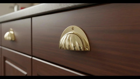 Brass Cup Handle With Elegant Scalloped Shell Design Pack Of 4 for drawer and cabinet pulls in a side view installed on wooden cabinet