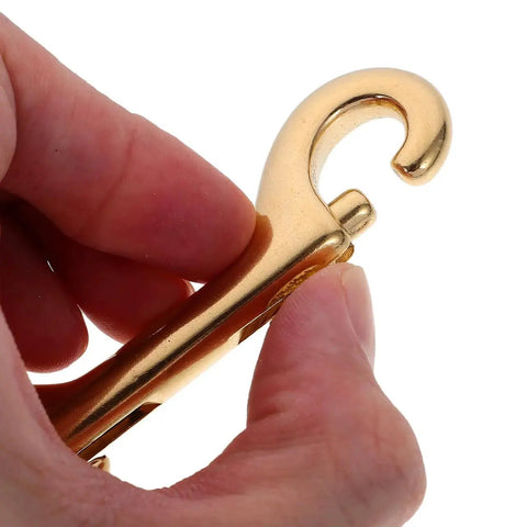 Close-up of hand holding one of the 4 Pack 3.5 Inch Brass Double Ended Bolt Snap Clips Heavy Duty for dog leashes and boating gear.