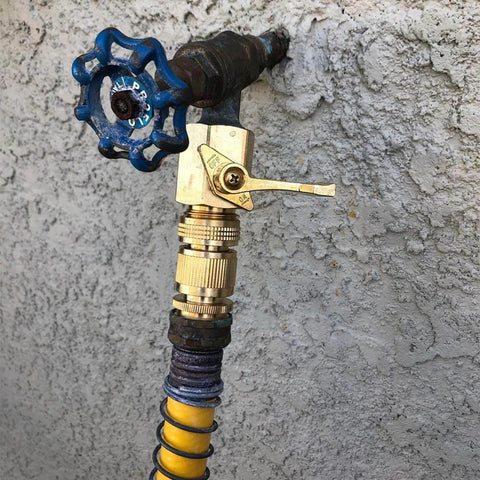 Solid Brass Garden Hose Quick Connect Set With 3/4 Inch GHT attached to outdoor faucet, blue handle, hose view