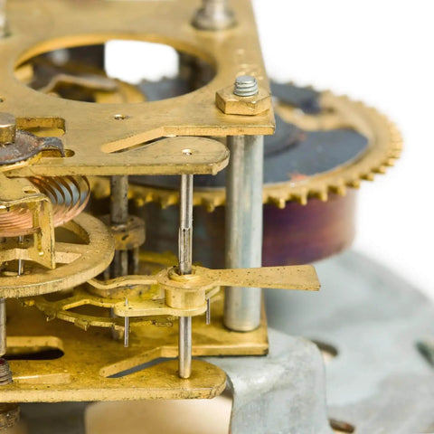Close-up of clockwork mechanism showing brass gears and metal rods for DIY crafts and modeling projects