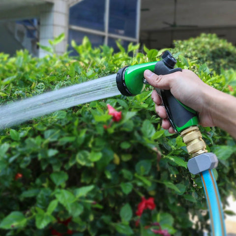 Hand using No Hassle Full Flow Brass Garden Hose Quick Release Adapter Fitting With Male And Female Connectors watering plants