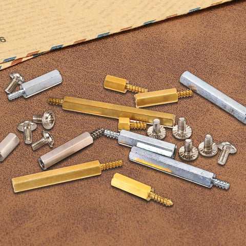 Brass M3 Hex Standoffs 12 Pack For Motherboard With 6mm Male To Female Studs And Copper Spacers Pillars 14mm Total Length Includes M3 X 6mm Screws Durable Copper Construction For Solid PC Build on wooden surface