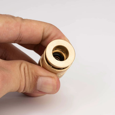 Close-up of 1/4-Inch Quick Connect Fittings Set For Air Compressors - Brass Air Coupler with knurled sleeve, held in hand