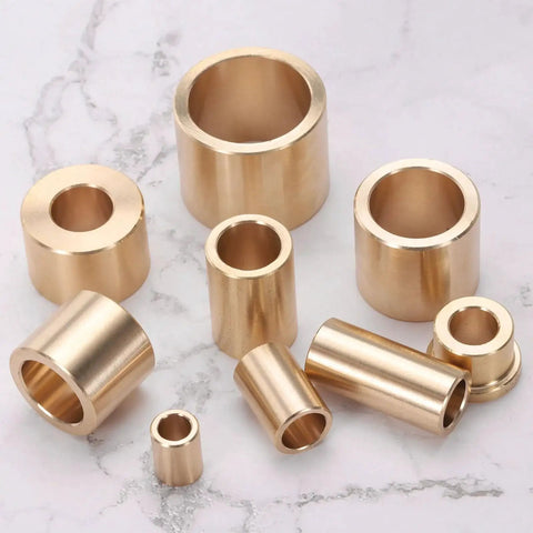 Assorted brass sleeve bearings on a marble surface, including Brass Sleeve Bearings 10mm Bore 14mm OD 30mm Length Self Lubricating Bushing 2 Pack Cast Brass Plain Bearing For Low Friction Linear Motion And High Sliding Velocity Applications Ideal For Industrial Machinery.