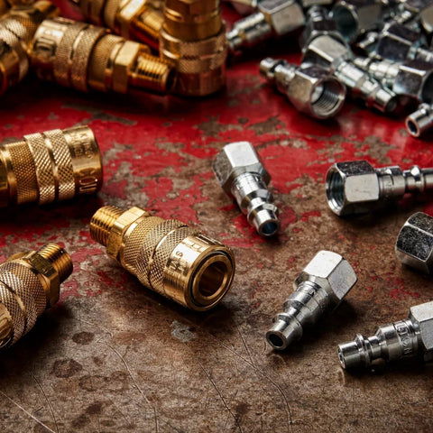 M-Style One Quarter Inch Male NPT Air Quick Connect Coupler For Industrial Use with Kwik-Change fittings on metal surface