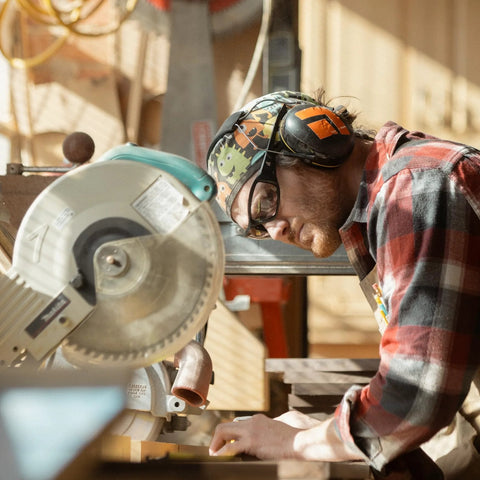 Person wearing Brazeau Polarized Safety Glasses With 99.9 Percent UV Protection And ANSI Z87 working with a saw outdoors.