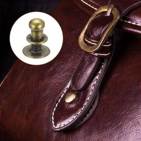 Close-up of bronze 5mm Ball Head Stud Rivets With Screw Back on leather handbag, showcasing nipple rivet design and buckle detail.