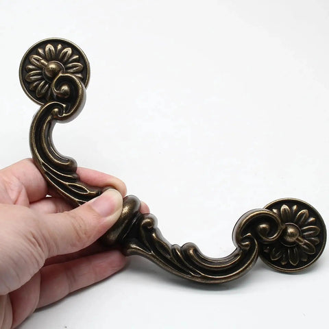 Close-up of Vintage Drop Bail Drawer Pulls 6 Inch Center To Center 150mm Bronze Zinc Alloy Cabinet Handles with floral design.