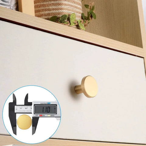 Eight Piece Brushed Brass Cabinet Knob Set With Solid Round Hardware for kitchen cabinets shown installed on drawer