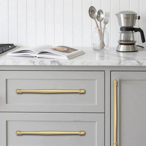 2 Pack 4 Inch Center To Center Brushed Gold Cabinet Pulls installed on gray kitchen drawers with marble countertop