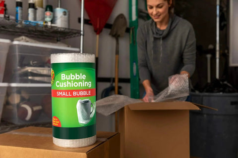 Bubble Wrap Protective Packaging 12 Inch Wide 30 Foot Roll Clear Bubble Cushions For Delicate Items being used to pack a box