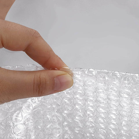 Close-up of a hand tearing perforated 2 Pack 12 Inch Bubble Packing Wrap 72 Feet Perforated Every 12 Inches for Moving Boxes and Shipping Cushioning.
