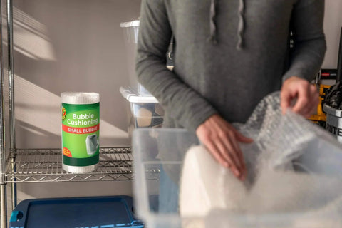 Person packing with Bubble Wrap Protective Packaging 12 Inch Wide 30 Foot Roll Clear Bubble Cushions For Delicate Items