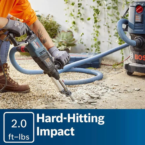 Person using Bosch Bulldog Extreme 1 Inch SDS Plus Rotary Hammer for chiseling concrete, demonstrating powerful corded performance.