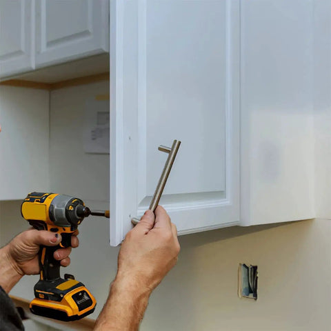 Person using a drill to install cabinet handle with Assorted M4 Cabinet Screws Kit 25 to 50mm Black Zinc Pan Head Phillips Machine Screws 100 Pieces.