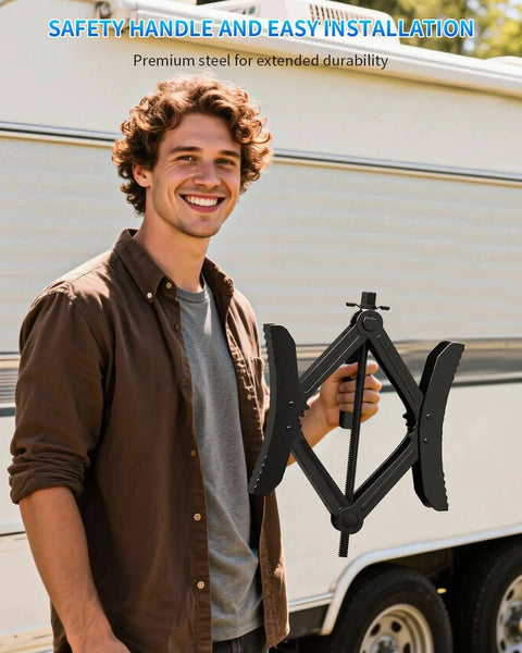 Man holding Heavy Duty X Shaped Camper RV Wheel Chock Stabilizer Two Pack With Wrench from BEBOBLY in front of a trailer.