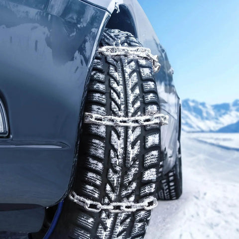 Car tire with snow chains on snowy road, featuring ✝️ Proof Coil Chain, 1/8" x 100', 330 lbs Safe Working Load, Zinc Plated Proof Tested.