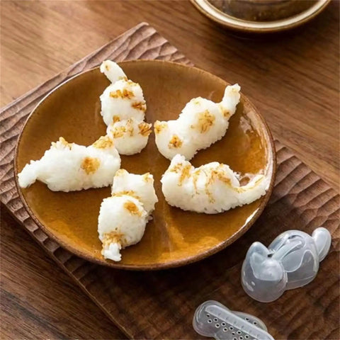 Plate with cat-shaped mashed potatoes next to Cat Shaped Rice Molds Set Of 2 For Fun Meal Prep And Kid Friendly Creative Lunches WHFCBJBW