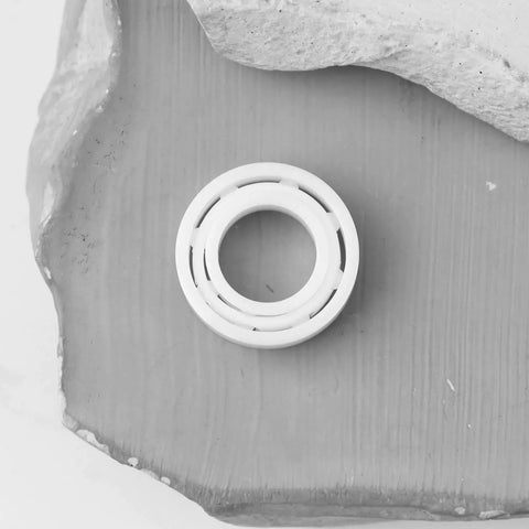 2 Pcs MR137 Full Ceramic ZrO2 Ball Bearings 7x13x4mm on a textured surface for optical instruments and machinery