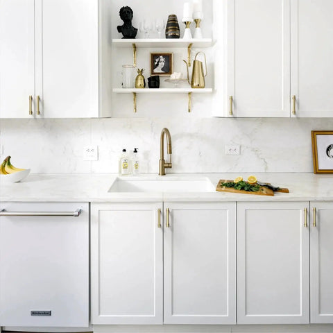 White kitchen with Champagne Bronze Cabinet Pulls 10 Pack 3 Inch Hole Center Zinc Alloy Handles installed on cupboards and drawers.