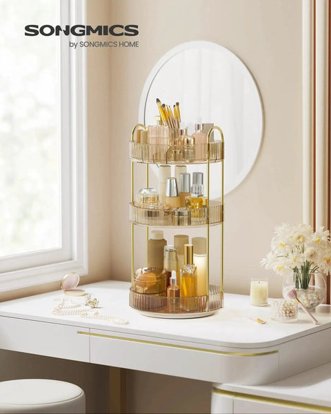 Three Tier Round Rotating Makeup And Skincare Organizer for countertop vanity in champagne gold, filled with cosmetics, reflected in a mirror.