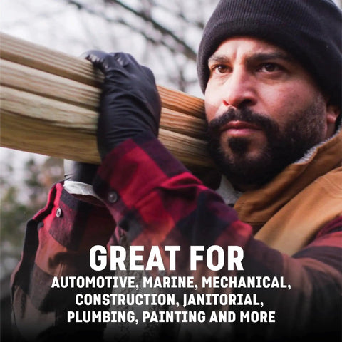 Man wearing Chemical Resistant Black Nitrile Gloves Two Layer Protection 6 Mil Powder Free carrying wooden planks outdoors