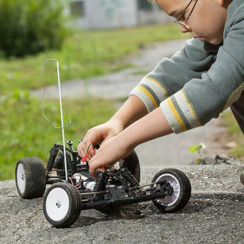 Child working on RC car outdoors, perfect setting for using 4mm x 300mm 304 Stainless Steel Solid Round Rod for DIY Craft - 5pcs