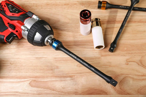 Foot/Pound Torque Limiting Extension Bar - Chrome Moly 1/2-Inch Drive 8-Inch Long Impact Grade Bar with Flex Action attached to drill on wooden surface