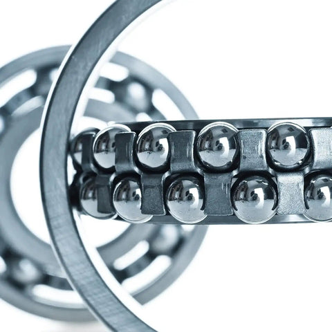 Close-up of 12 Pack Five Eighth Inch Chrome Steel Bearing Balls G25 Precision Grade Mirror Finish in a ball bearing assembly.