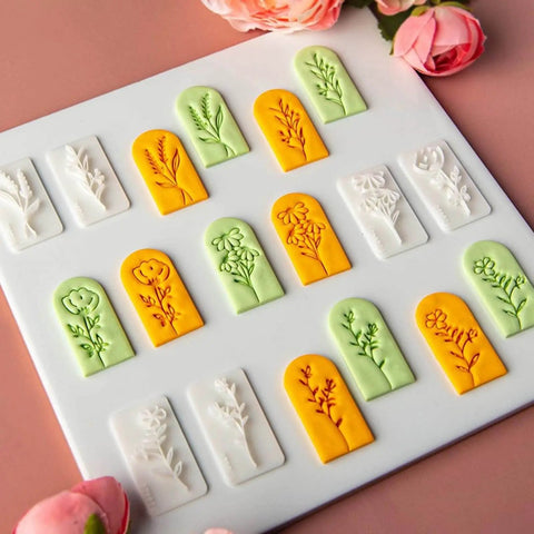 7 Piece Soft Clay Leaf Cutter Mold Set For Flower Stamps And Floral Earrings Making Tools Jewelry Craft Kit For DIY Artists Plastic Jewelry Molds For Flawless Impressions And Creative Workshops in white, orange, and green on a board