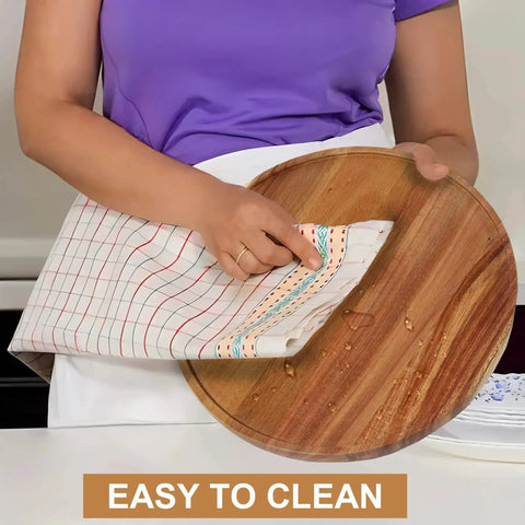 Two Pack 10 Inch Acacia Wood Lazy Susan Turntables being wiped clean with cloth, shows durability and easy maintenance