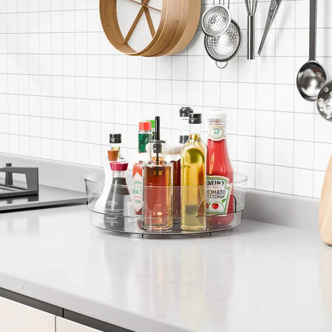 Clear 12 Inch Lazy Susan Turntable Set With Handles 4 Pack Acrylic Spinning Organizer on countertop with condiments and sauces